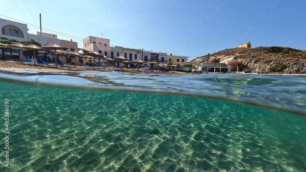 Underwater split photo taken from beautiful emerald bay and beach of Kapsali, Kythira island, Ionian, Greece Underwater split photo taken from beautiful emerald bay and beach of Kapsali, Kythira island, Ionian, Greece