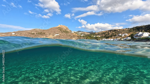 Underwater split photo taken from beautiful emerald bay and beach of Kapsali overlooking famous castle of Kythira island, Ionian, Greece