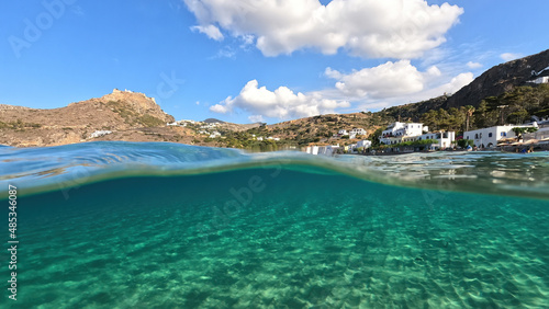 Underwater split photo taken from beautiful emerald bay and beach of Kapsali, Kythira island, Ionian, Greece © aerial-drone