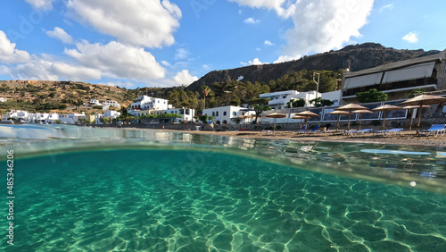 Underwater split photo taken from beautiful emerald bay and beach of Kapsali and famous Monastery of Saint John at the background, Kythira island, Ionian, Greece