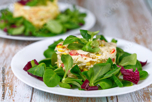 appetizing vegetarian fresh vegetable salads on white plates.