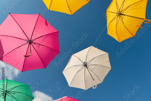 Colourful umbrellas urban street decoration  hanging colourful umbrellas on the blue sky  tourist attraction