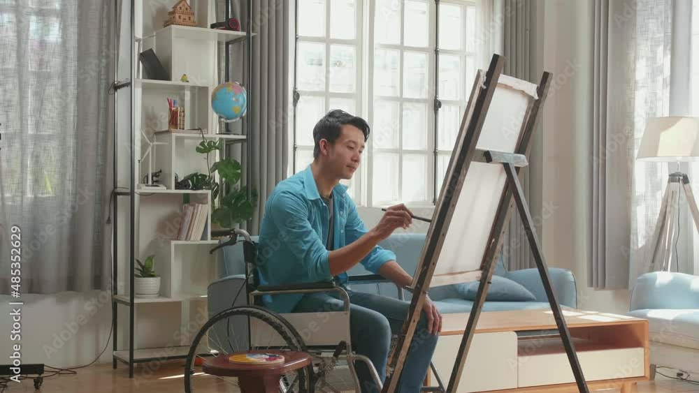 Side View Of An Asian Artist Man In Wheelchair Holding Paintbrush Mixed Colour And Thinking Before Painting On The Canvas
Side View Of An Asian Artist Man In Wheelchair Holding Paintbrush Mixed Colour And Thinking Before Painting On The Canvas