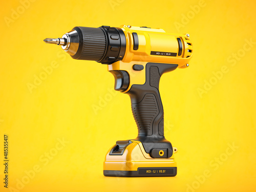 Yellow electric screwdriver drill  on yellow background photo