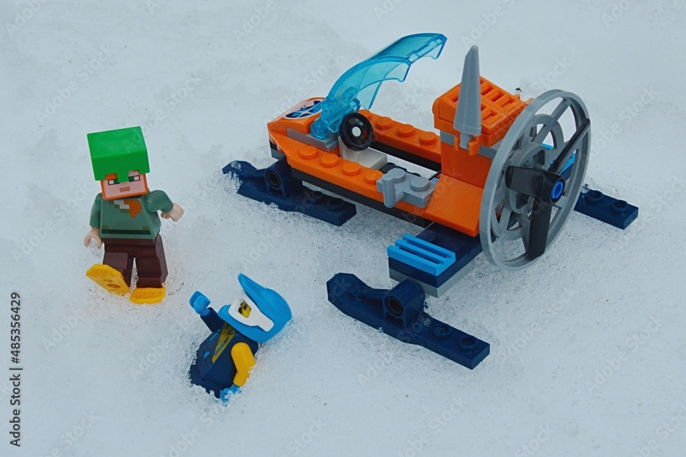 LEGO Minecraft figure of Alex with snowshoes and emerald helmet is rushing to help LEGO City Ice