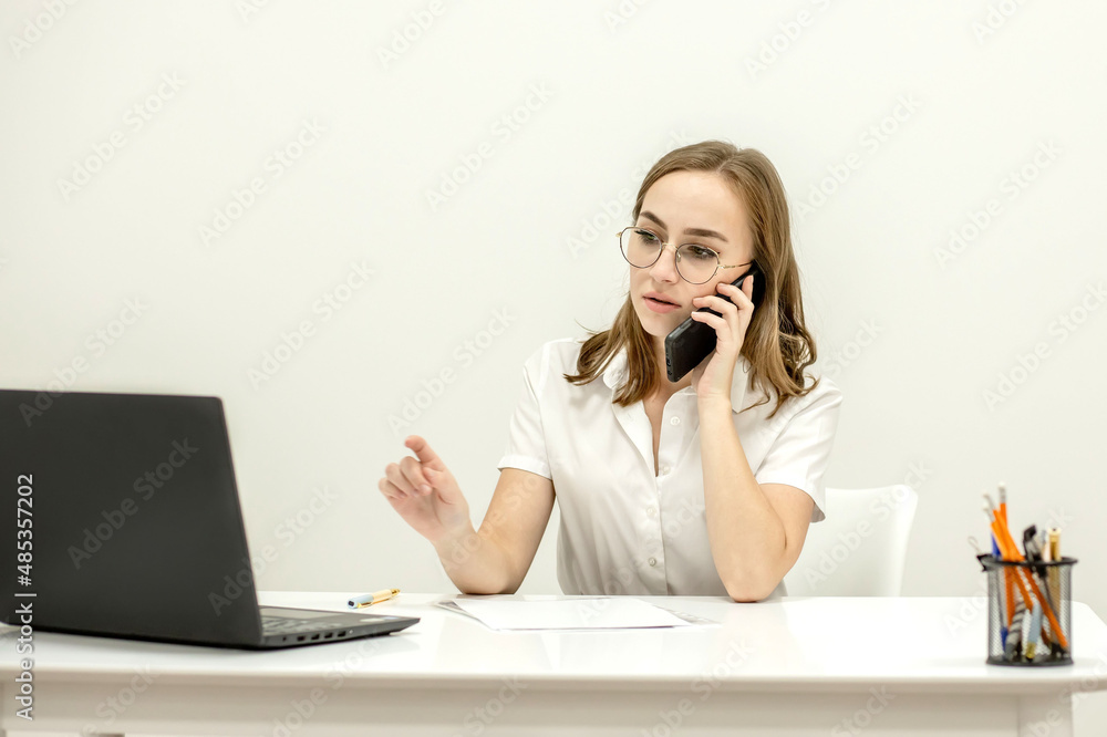 Beautiful secretary in spectacles is checking her boss is meeting to arrange another one. She is friendly and smiling Beautiful secretary in spectacles is checking her boss is meeting to arrange another one. She is friendly and smiling