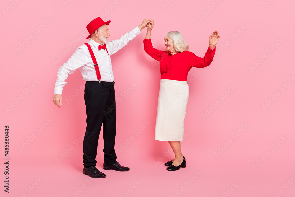 Full length body size view of attractive cheery gray-haired couple dancing rest isolated over pink pastel color background Full length body size view of attractive cheery gray-haired couple dancing rest isolated over pink pastel color background