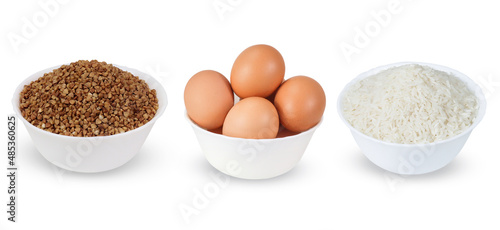 Chicken eggs, rice and buckwheat  in a bowl isolated on a white background.  Set of full white bowl