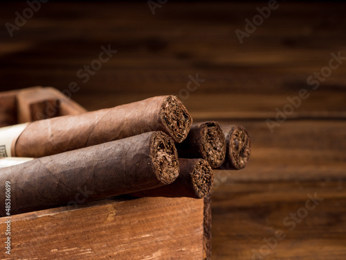 Cigars in a wooden box on a wooden table. Copy space. © Alexandr_kort