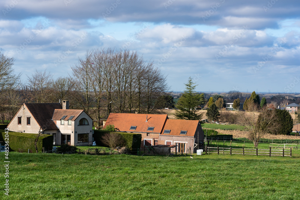 Meise, Flemish Brabant Region, Belgium - 02 05 2022: View over village urbanisation and farmland with a blue sky