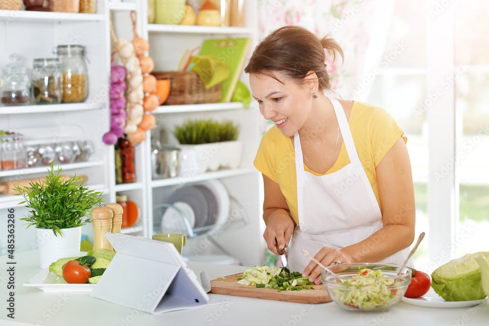 beautiful young woman cooking in kitchen