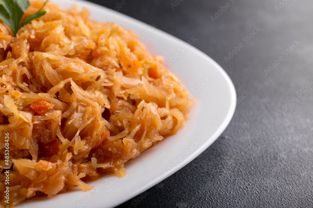Traditional Homemade Stewed cabbage on white plate. Traditional Homemade Stewed cabbage on white plate.