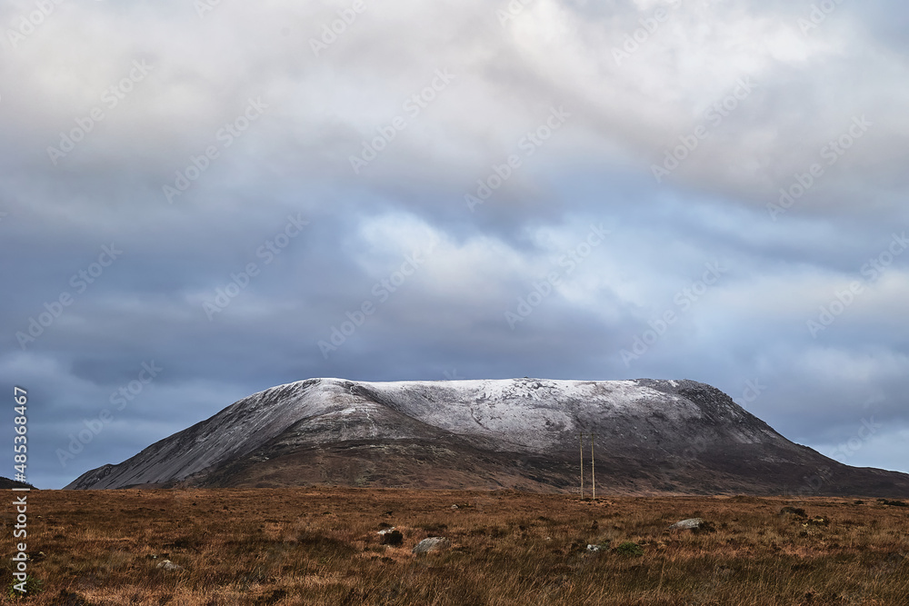 Errigal mountain. County Donegal. snowy peak in winter with cloudy sky and beautiful colors