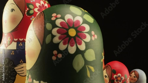 A family of matryoshka dolls in close-up on a Zhostovsky dish. photo