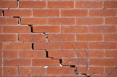 Red Brick Wall with Large Crack and crumbling mortar