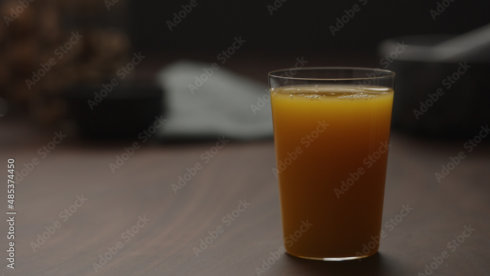 pumpkin juice in tumbler glass from wood table with copy space
