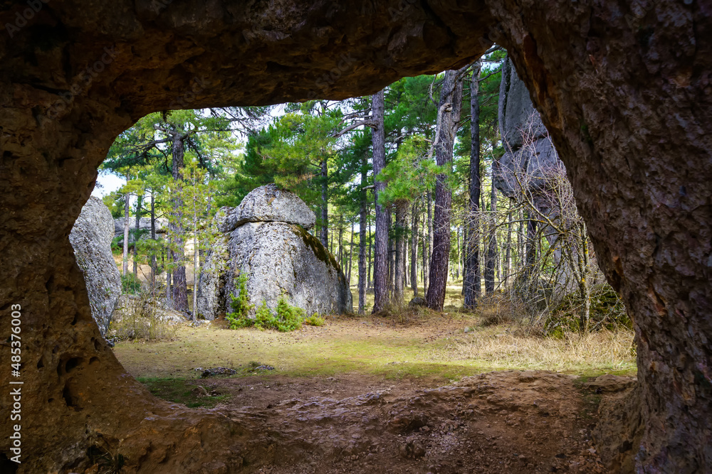 Rocky cave framing the forest of the Enchanted City of Cuenca Spain.