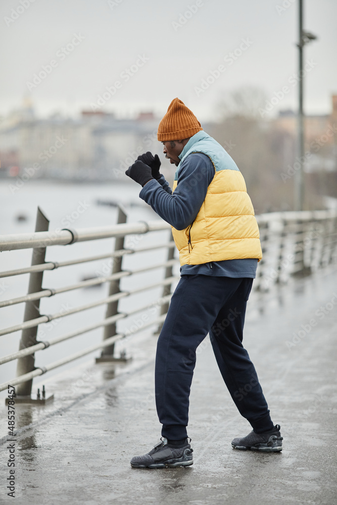 Active young man of African ethnicity in sportswear practicing physical exercise during outdoor training in the morning Active young man of African ethnicity in sportswear practicing physical exercise during outdoor training in the morning