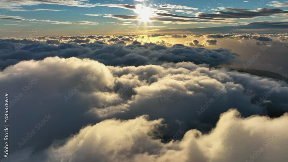 Top view of the clouds in the morning light. Aerial view of cumulus clouds. Sunlighten cumulus clouds under horizon. Clear sky over the cumulus clouds in the morning.Over the clouds. Top view of the clouds in the morning light. Aerial view of cumulus clouds. Sunlighten cumulus clouds under horizon. Clear sky over the cumulus clouds in the morning.Over the clouds.