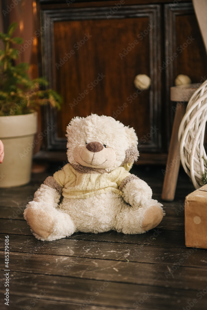The stylish interior of the children's room with wooden furniture and a rustic wigwam is decorated for Christmas