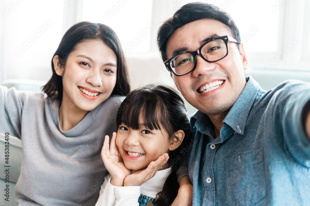 small asian family portrait at home