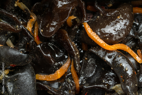 black mushrooms with Korean carrots closeup. asian food