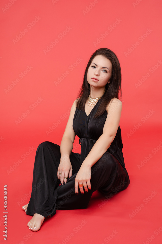 Beauty girl in fashionable black overall and heels. Beauty girl in fashionable black overall and heels.