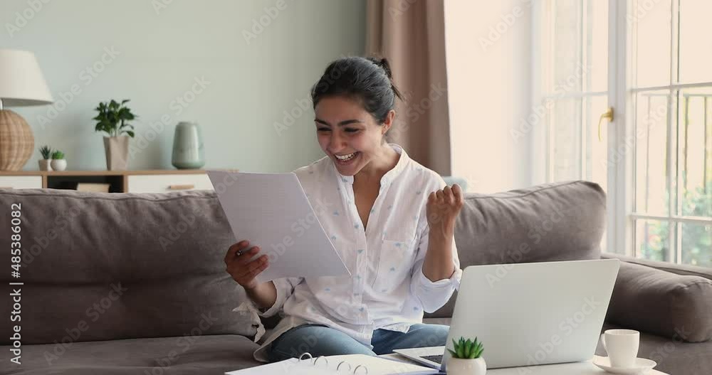 Overjoyed Indian woman read good fantastic news in paper letter, got bank notice about loan approval, celebrates business or personal success. Achievement, new job opportunity, taxes refund concept Overjoyed Indian woman read good fantastic news in paper letter, got bank notice about loan approval, celebrates business or personal success. Achievement, new job opportunity, taxes refund concept