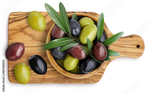 Green, black and red ripe olives with leaves on wooden board, isolated on white background, view from above