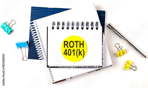 Photos Sticker with ROTH 401K text on notebooks on the white background