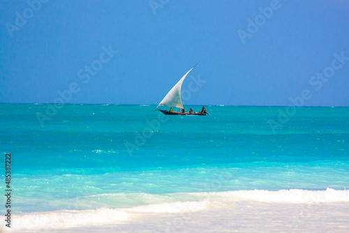 Traditional african sailboat in azure water of Indian ocean. Zanzibar, Tanzania