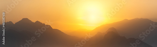 orange panorama - misty mountains at sunset