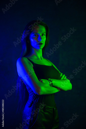 Woman with led lamps in the darkroom