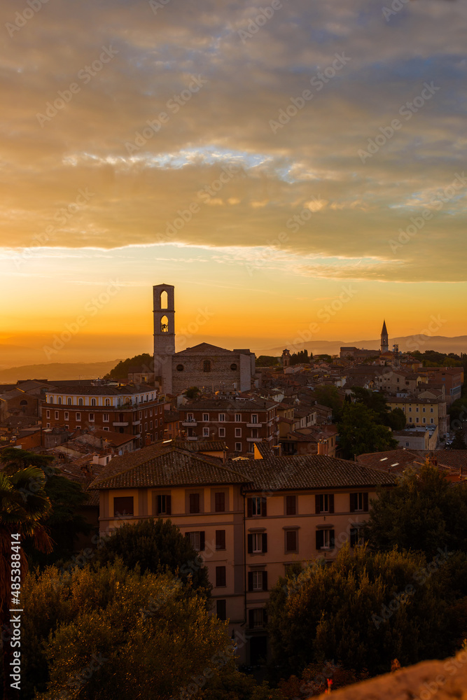 Beautiful dawn sky with morning haze over the old city of Perugia, with medieval bell towers and Umbria countryside in the background