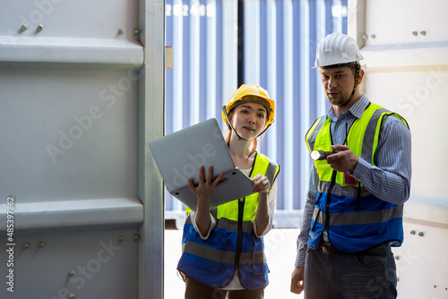 Foreman or worker work at Container cargo site check up goods in container. Foreman or worker checking on shipping containers. Logistics and shipping