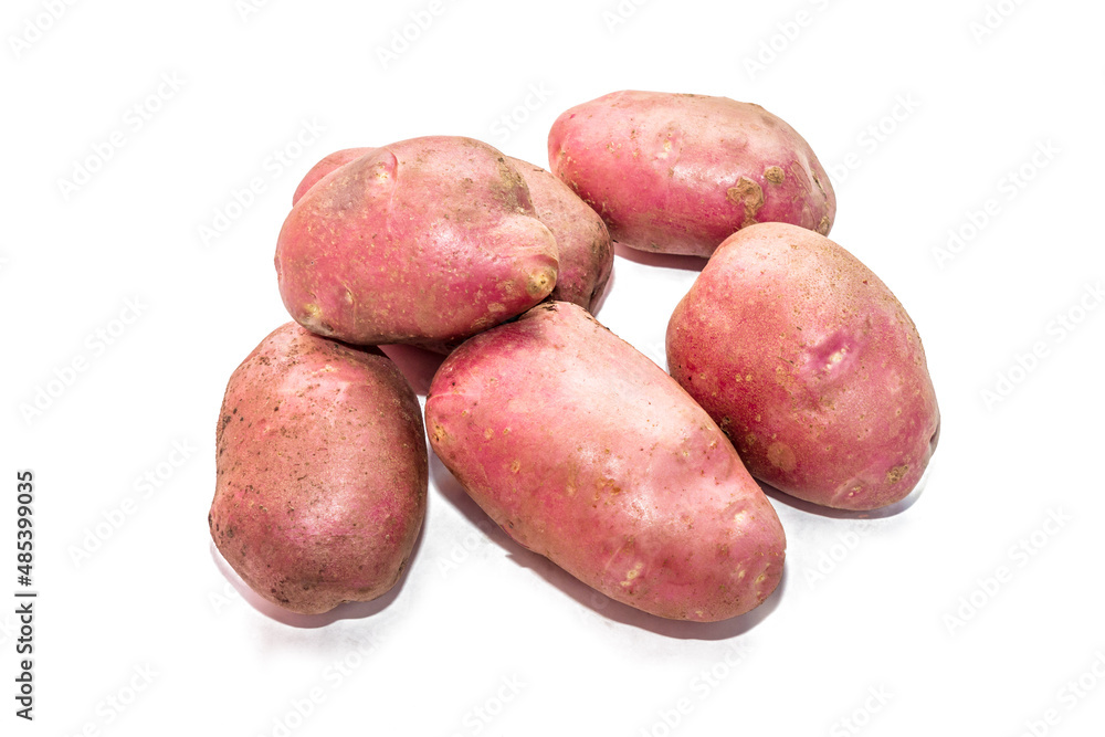 Potatoes on a white background. Varietal potatoes from the garden at the dacha. Scarlet Potatoes. Potatoes on a white background. Varietal potatoes from the garden at the dacha. Scarlet Potatoes.