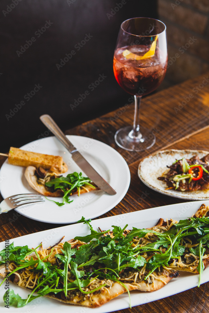 Sangria cocktail with appetizers of flat bread and bbq skewers