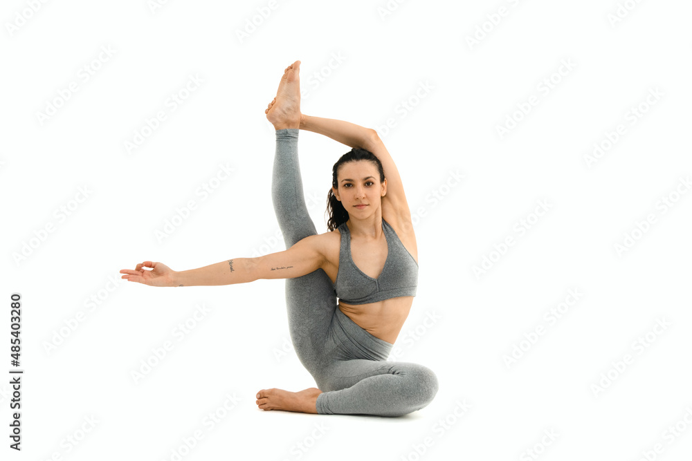 Woman doing yoga asana in white background. Black outfit. Ashtanga, Vinyasa, Hatha Woman doing yoga asana in white background. Black outfit. Ashtanga, Vinyasa, Hatha