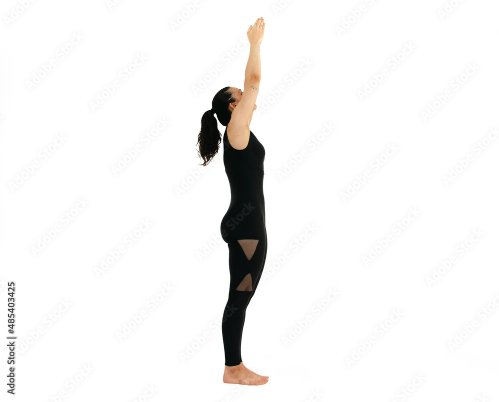 Woman doing yoga asana in white background. Black outfit. Ashtanga, Vinyasa, Hatha