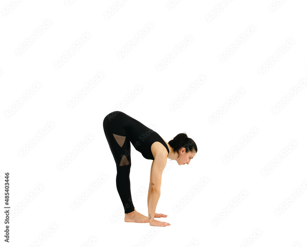 Woman doing yoga asana in white background. Black outfit. Ashtanga, Vinyasa, Hatha Woman doing yoga asana in white background. Black outfit. Ashtanga, Vinyasa, Hatha