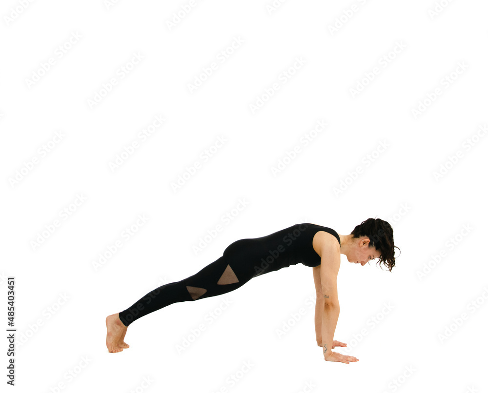 Woman doing yoga asana in white background. Black outfit. Ashtanga, Vinyasa, Hatha Woman doing yoga asana in white background. Black outfit. Ashtanga, Vinyasa, Hatha
