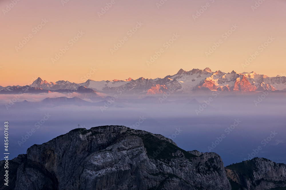 Scenic panorama of snowcapped mountain range at sunset. Swiss Alps near Luzern, Switzerland.