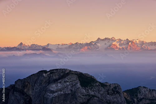 Scenic panorama of snowcapped mountain range at sunset. Swiss Alps near Luzern, Switzerland.