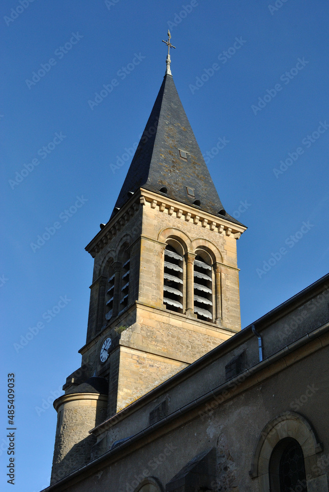Old Stone Church Tower and Spire seen from Below against Blue Sky