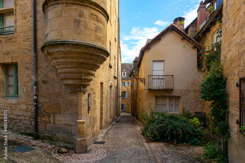 Fototapeta Naklejka Na Ścianę i Meble -  The narrow street of a beautiful french yellow stone medieval town of Perigord