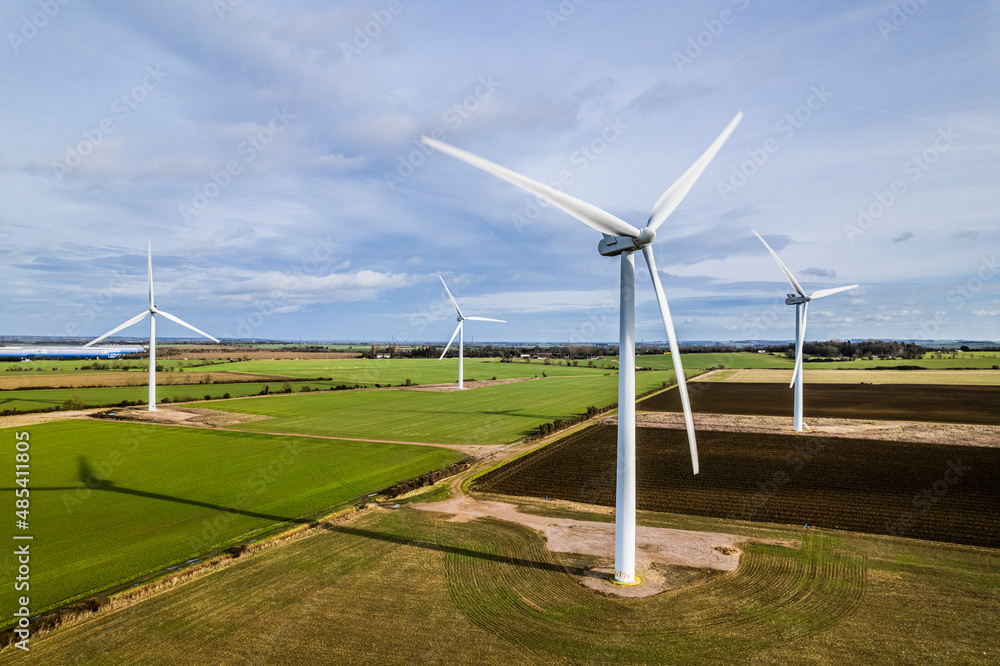Aerial shot of wind farm turbines in farmland, UK Aerial shot of wind farm turbines in farmland, UK