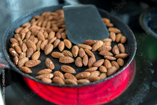 Frying almonds in a pan.