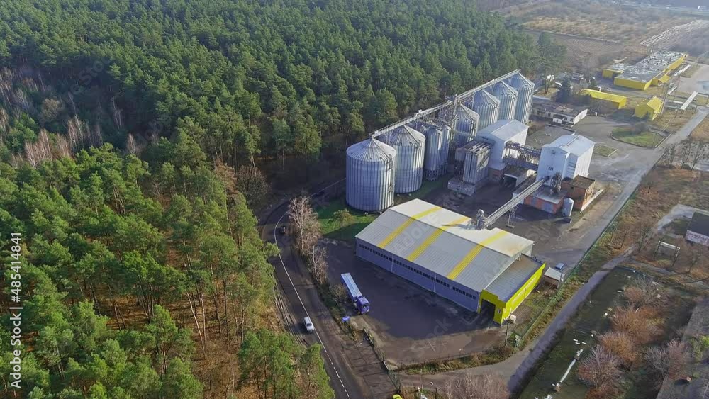 silver silos on agro manufacturing plant for processing drying cleaning and storage of agricultural products, flour, cereals and grain. silver silos on agro manufacturing plant for processing drying cleaning and storage of agricultural products, flour, cereals and grain.