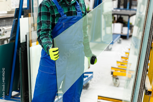 Obraz na płótnie The glazier carries a pane of glass in his hands, the Glass Factory w salonie