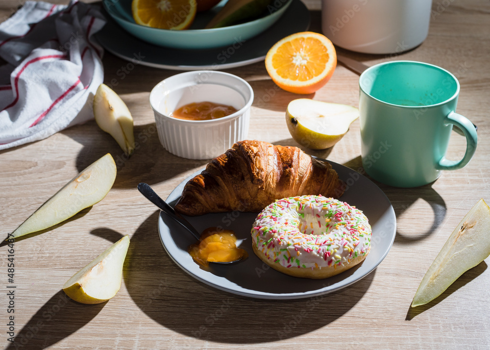 Healthy breakfast. Croissant, donut, coffee, jam, fruits: oranges and pears. Healthy breakfast. Croissant, donut, coffee, jam, fruits: oranges and pears.